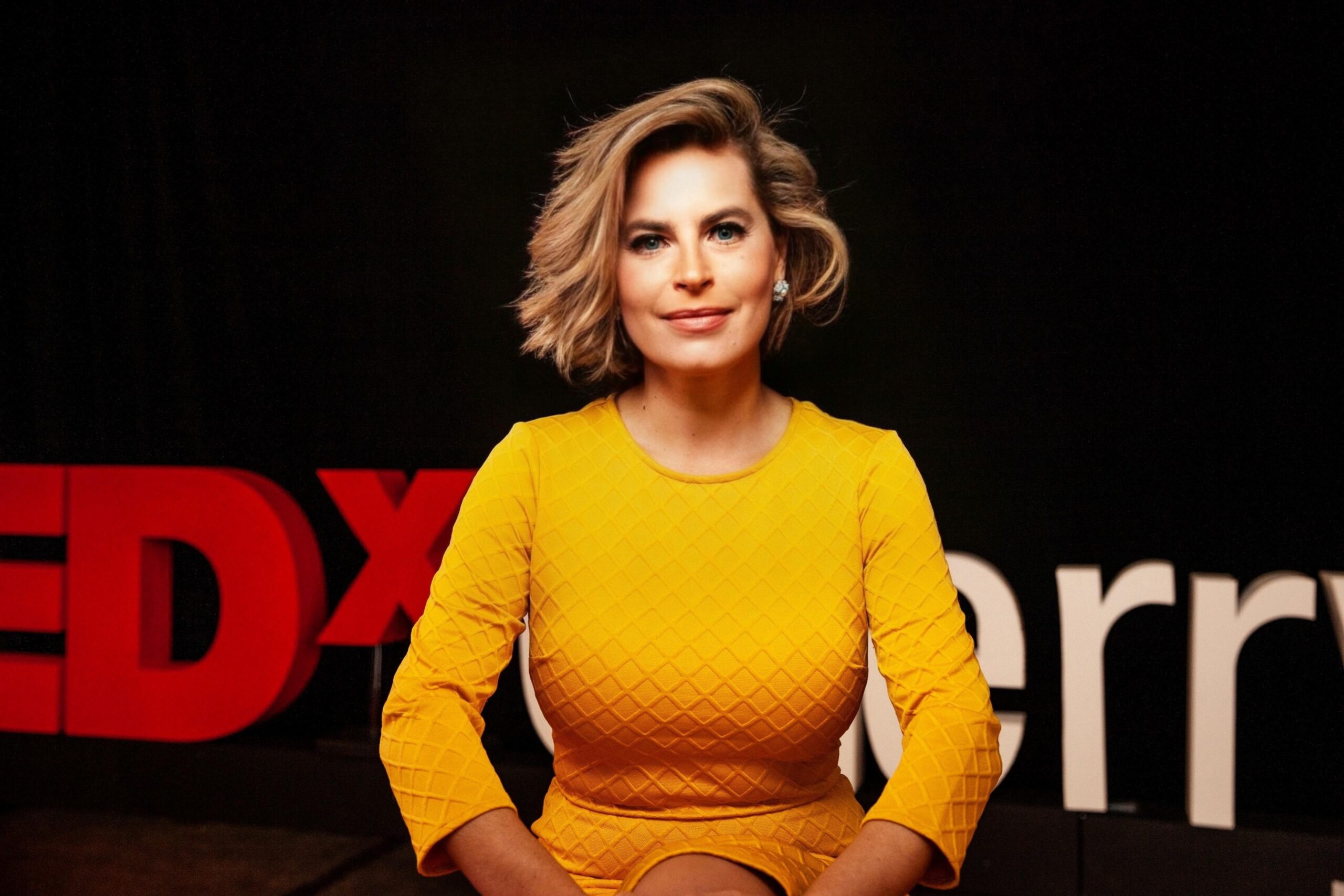 Olga V. Mack, a legal technology leader, in a bright coat and confident pose, embodying her role as a visionary in AI governance and strategy.
